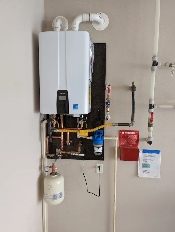 Professional plumber installing copper piping in a Eaton home